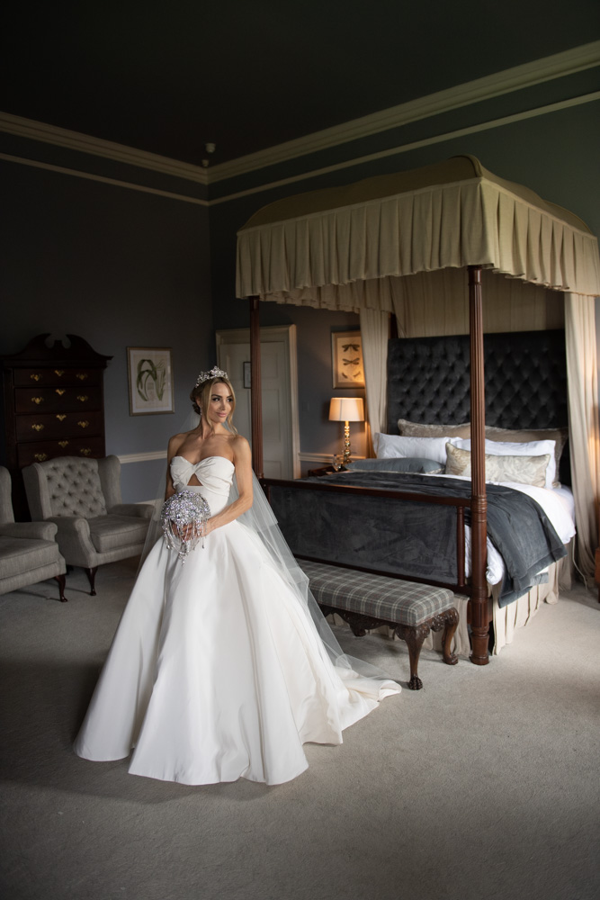 bride standing in Oscar De La Renta wedding dress in bridal suite