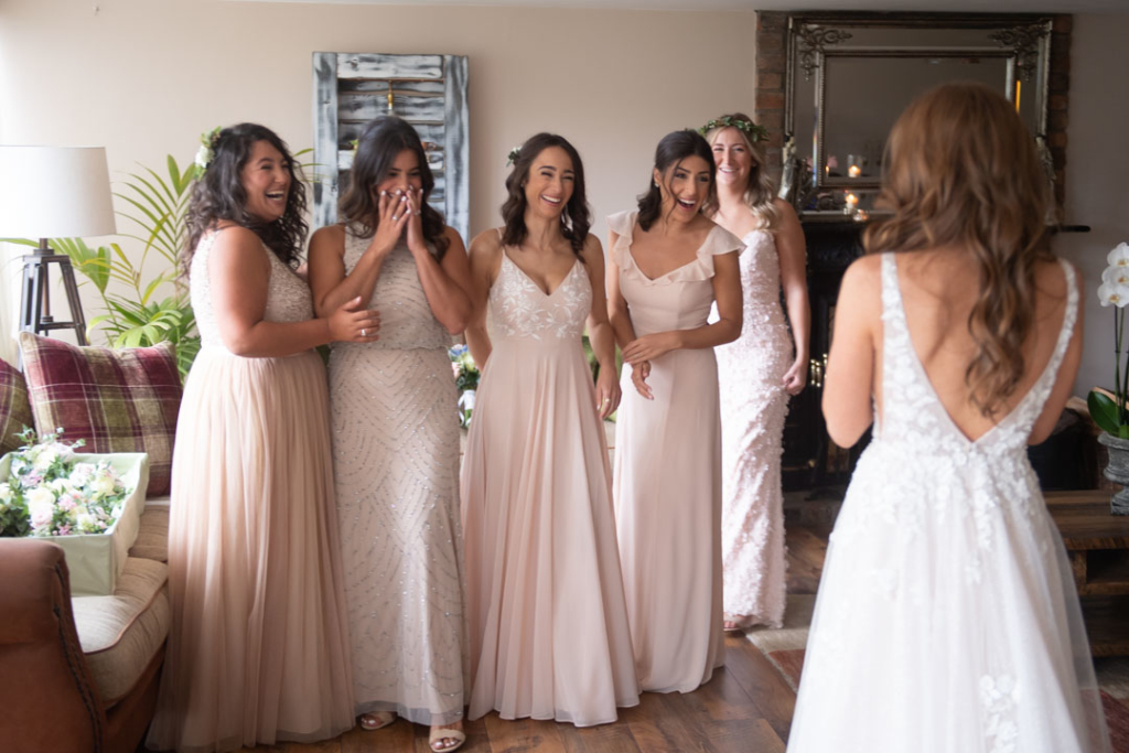 Bridesmaids seeing Bride for the first time in her wedding dress