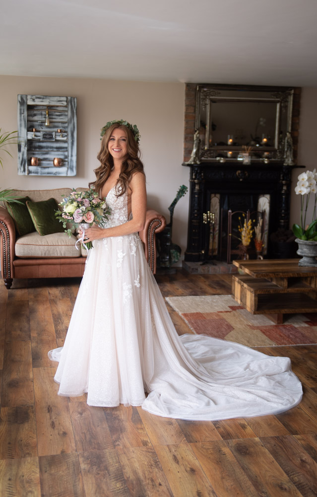 Bride in her blush wedding dress holding her flowers in ballymagarvey