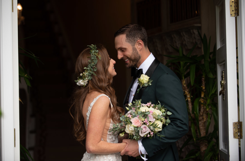 Bride and Groom looking and smiling at each other while holding hands