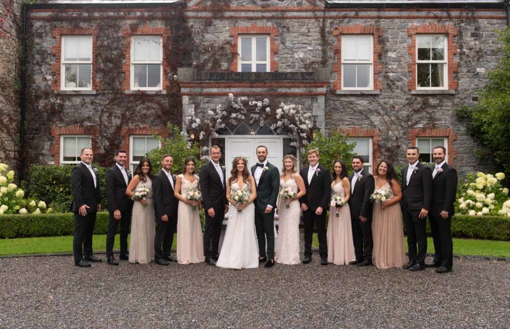 Bridal party standing in front of the house at Ballymagarvey Village