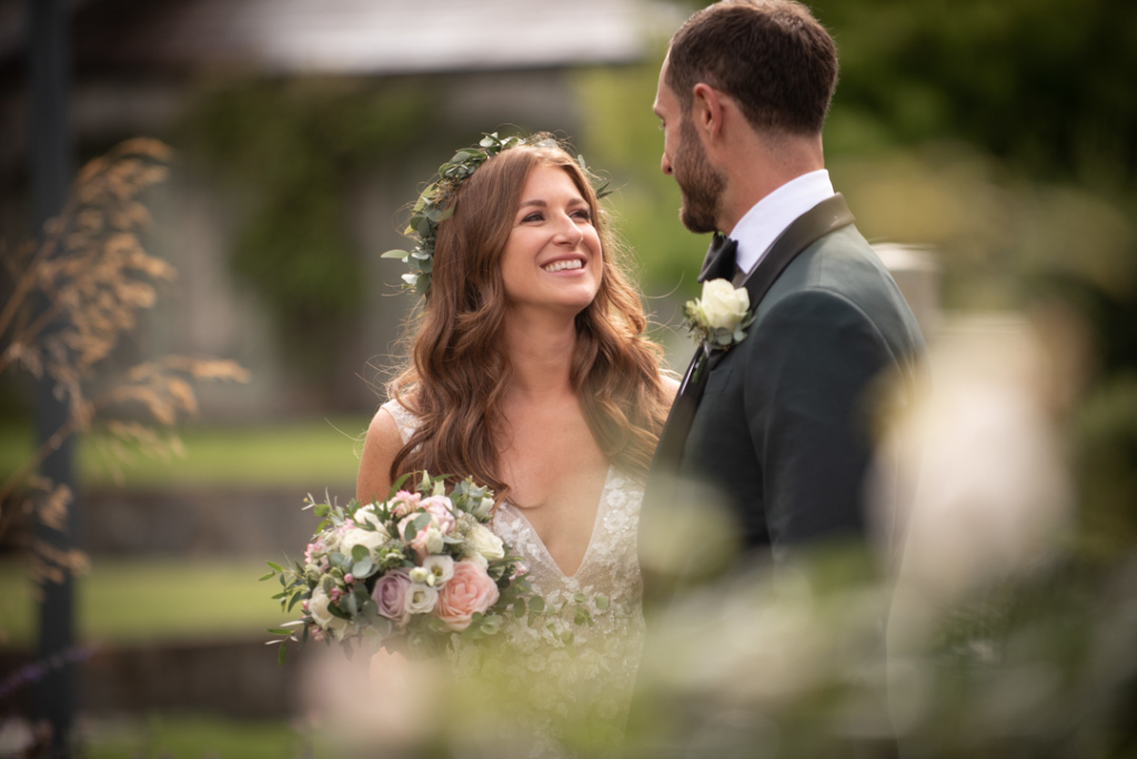 Bride and Groom smiling and looking at each other at Ballymagarvey Village