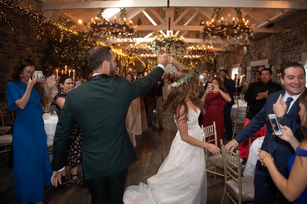 Groom twirling Bride as their guests cheer at Ballymagarvey Village