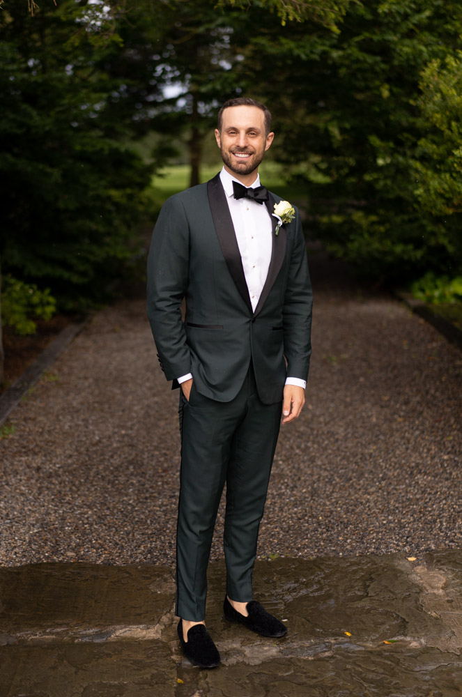 Groom in green suit and black bow tie in Ballymagarvey