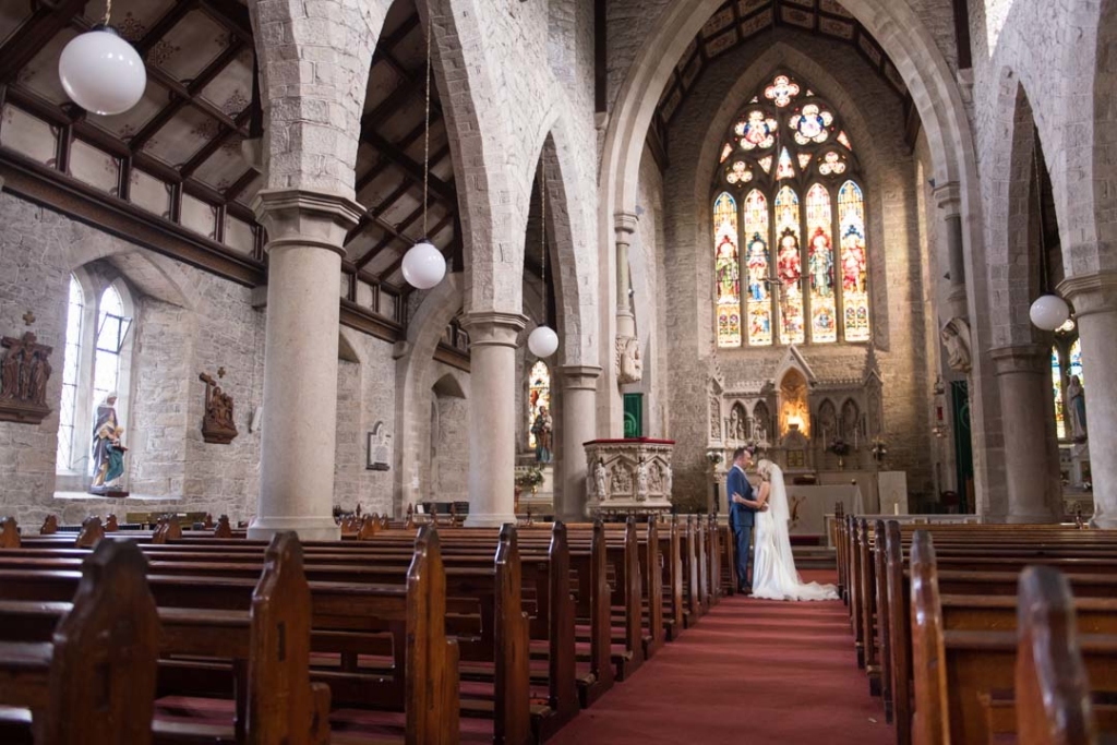 Bride and groom standing inside the Church while empty