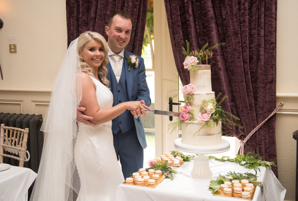 Bride and groom cutting the wedding cake at Brooklodge