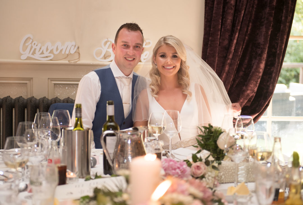 Bride and groom sitting at the top table at their Brooklodge wedding