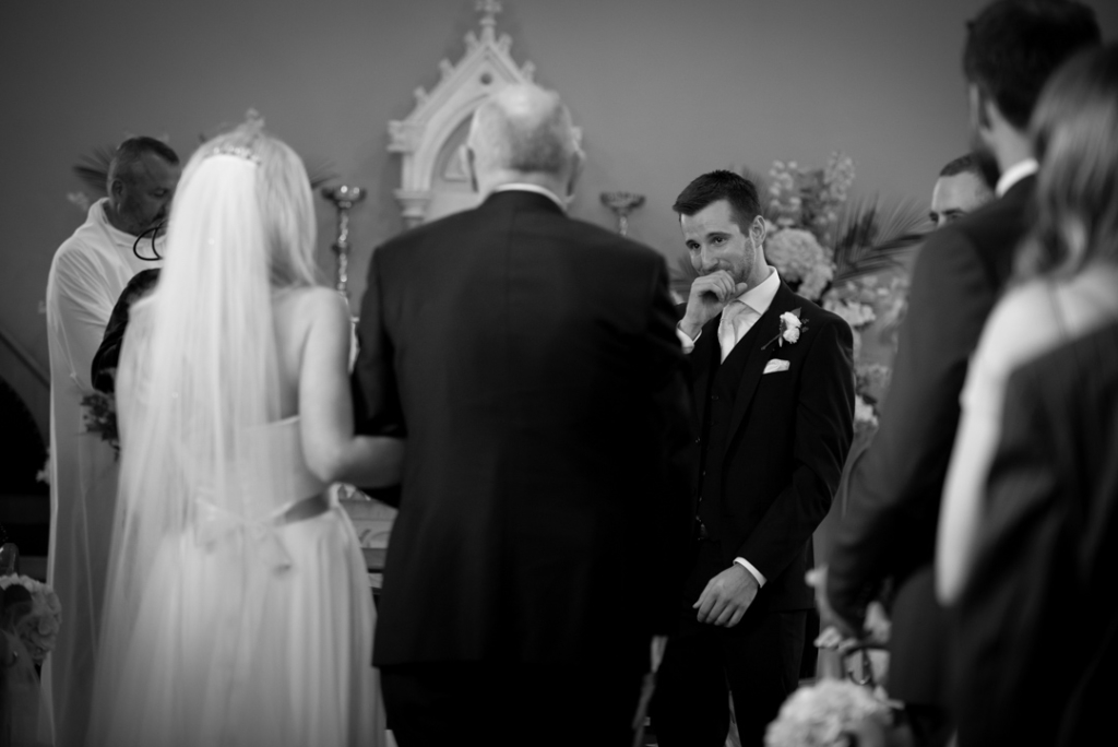 Groom crying as he sees his Bride walking down the aisle