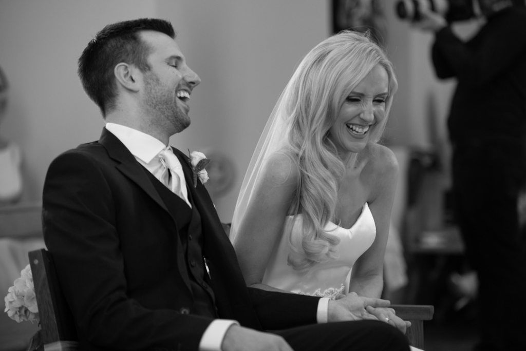 Bride and groom laughing in the Church