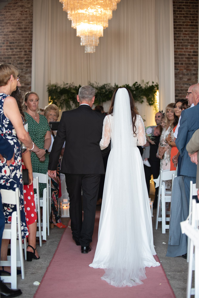 Back of Bride and her dad walking up the aisle at the Mill House Slane