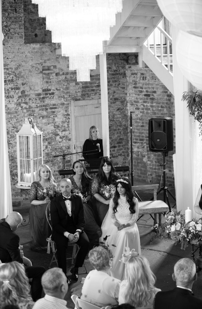 Bride and groom sitting at their wedding ceremony in the ceremony room in the Mill House Slane