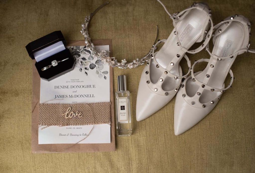 Brides wedding shoes, wedding invite, perfume and jewelery