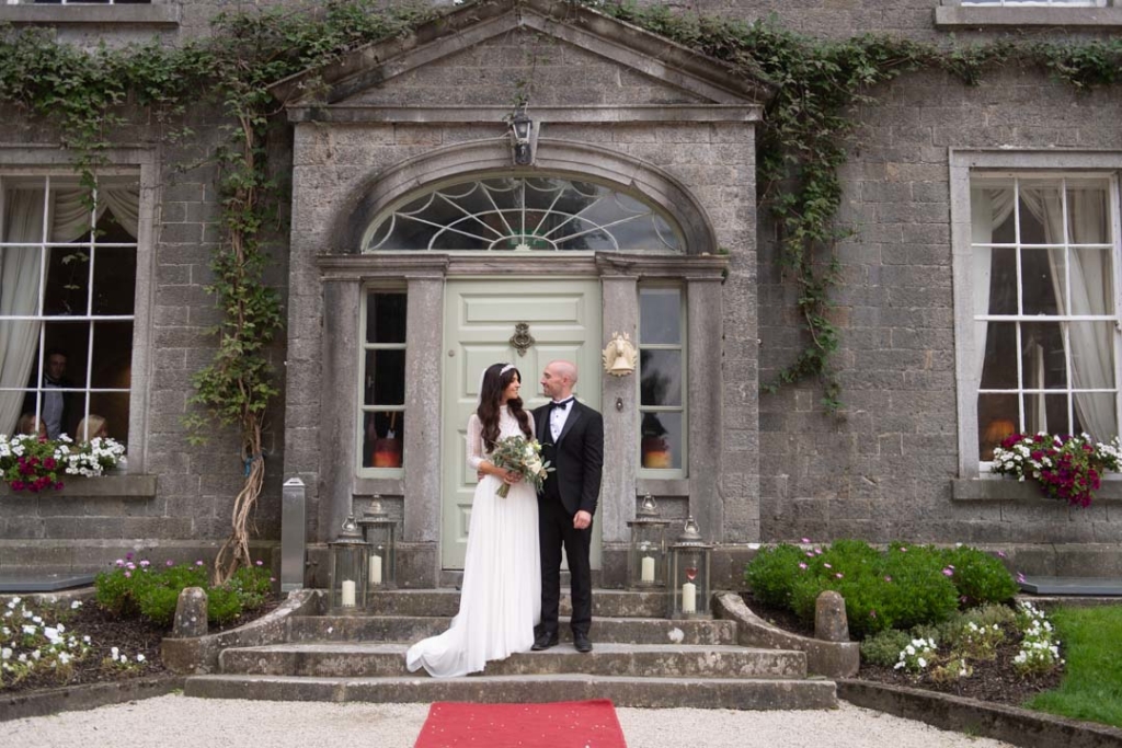 Bride and groom standing at the front door at the Mill House Slane wedding venue