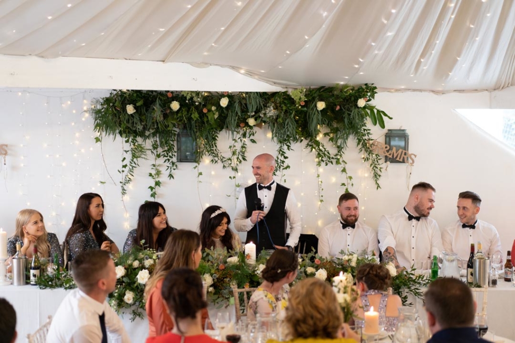 Groom standing at the top table while giving his speech