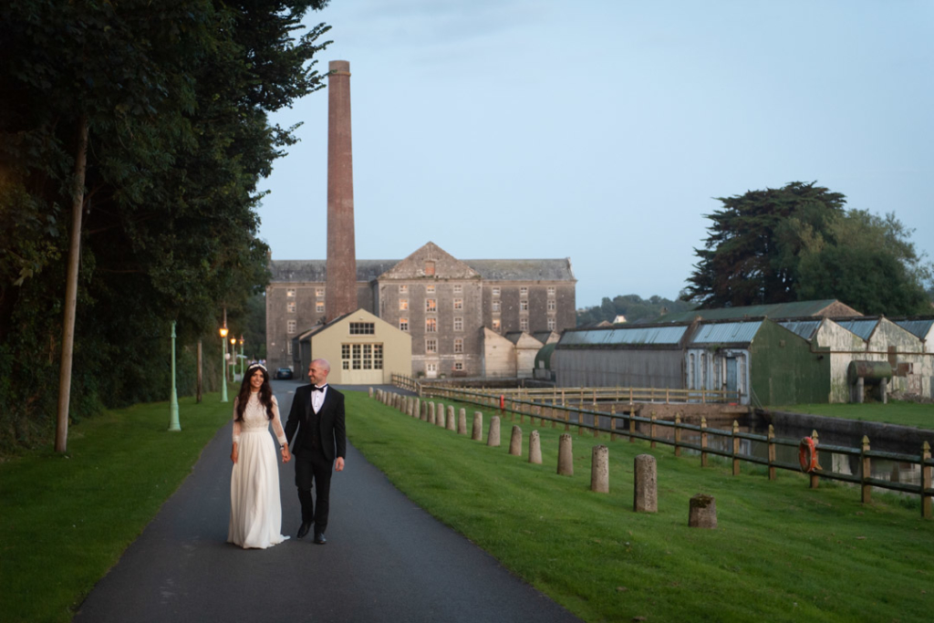 Bride and groom walking holding hands walking on the grounds of the Mill House Slane