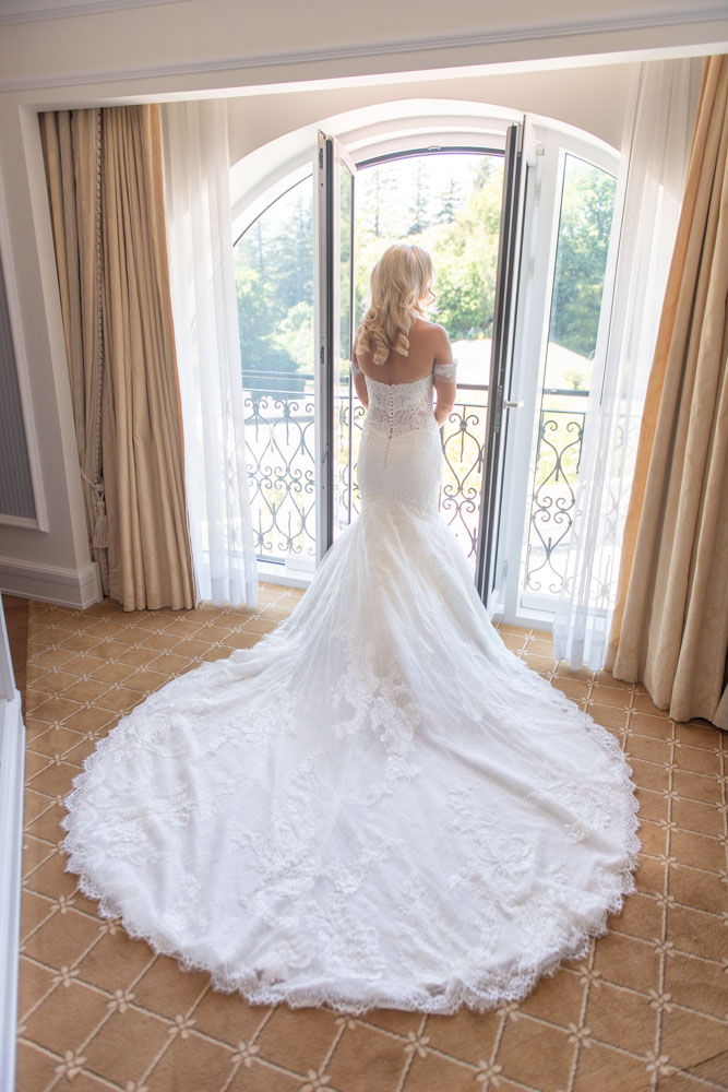 The back of the Bride in her wedding dress looking out the window at Powerscourt Hotel
