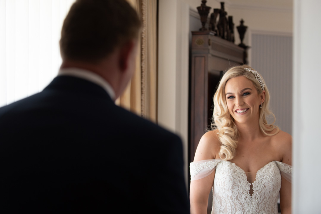 Bride seeing her dad for the first time in her wedding dress