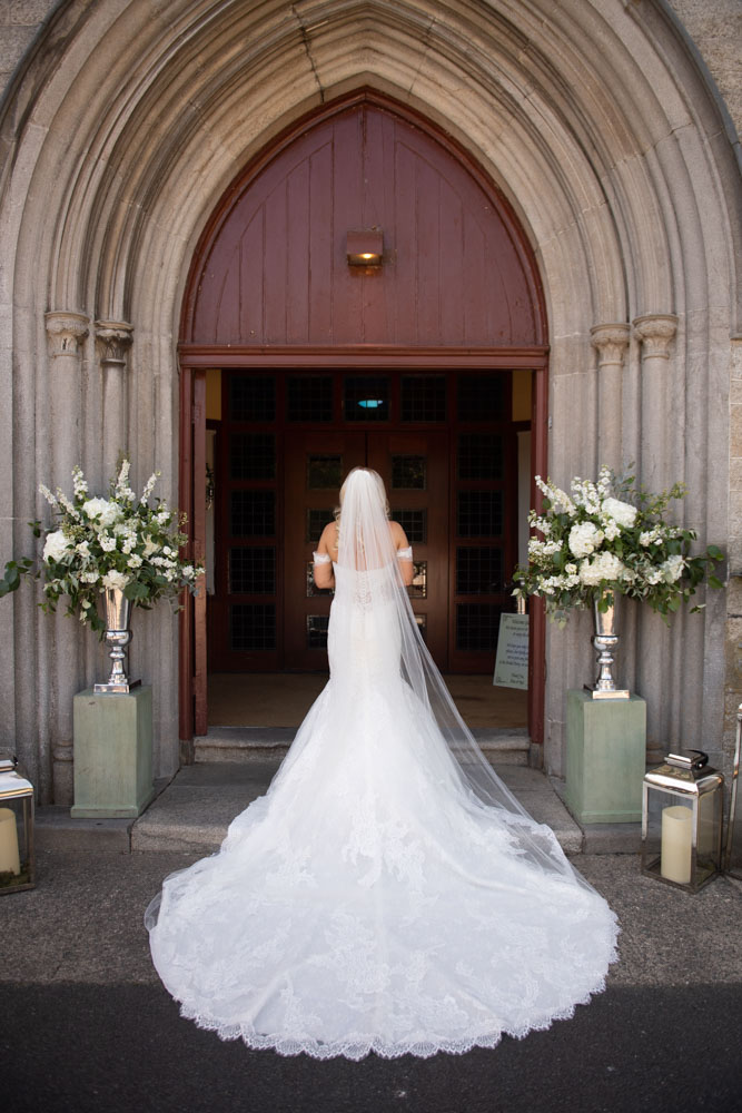 The back of the Brides dress and long train at the Church door
