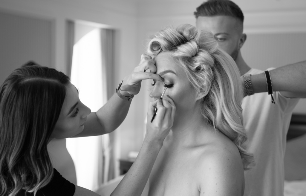 Bride getting her makeup applied and her hair styled