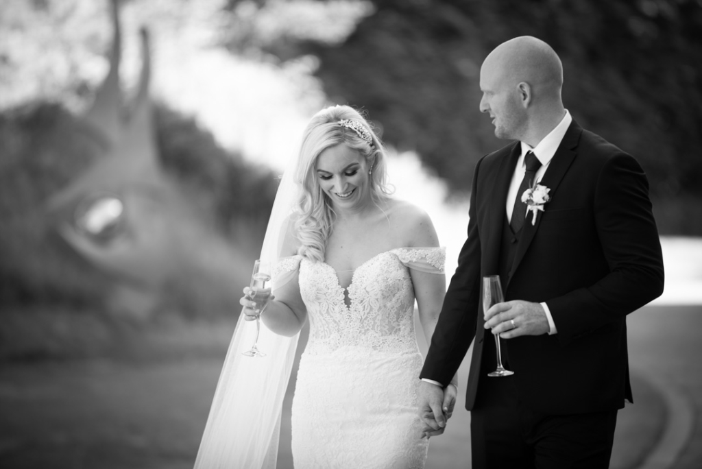 Bride and Groom walking and holding hands while chatting