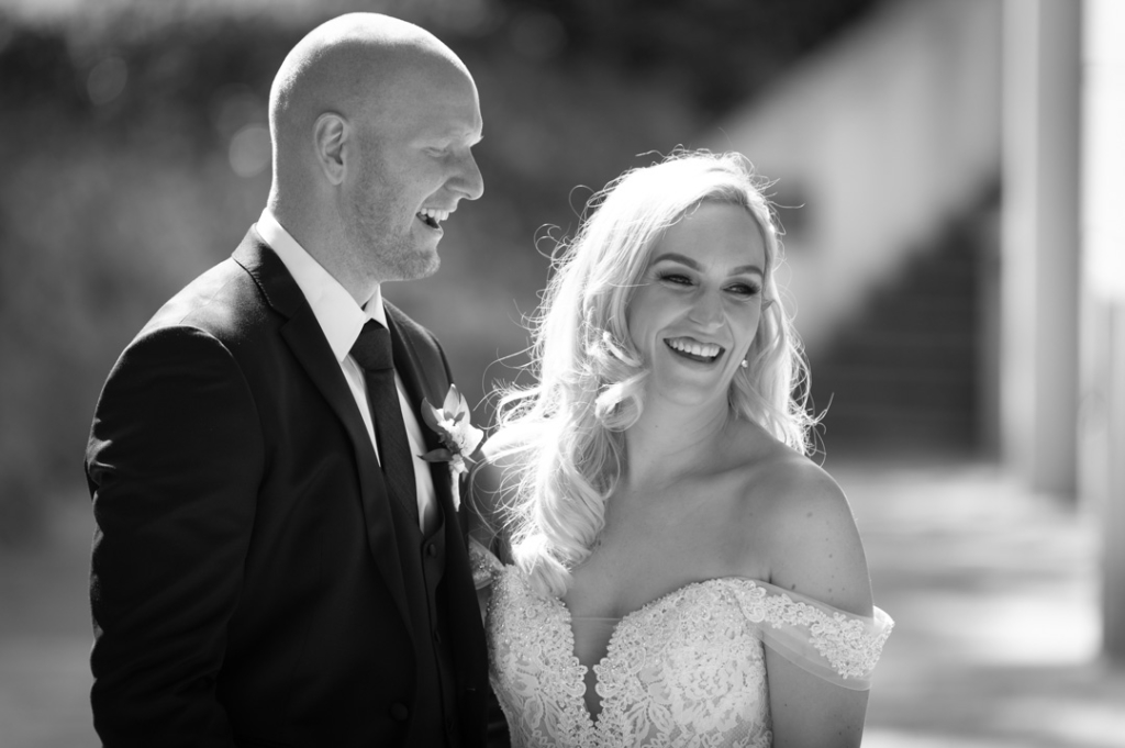 Black and white of Bride and Groom laughing together