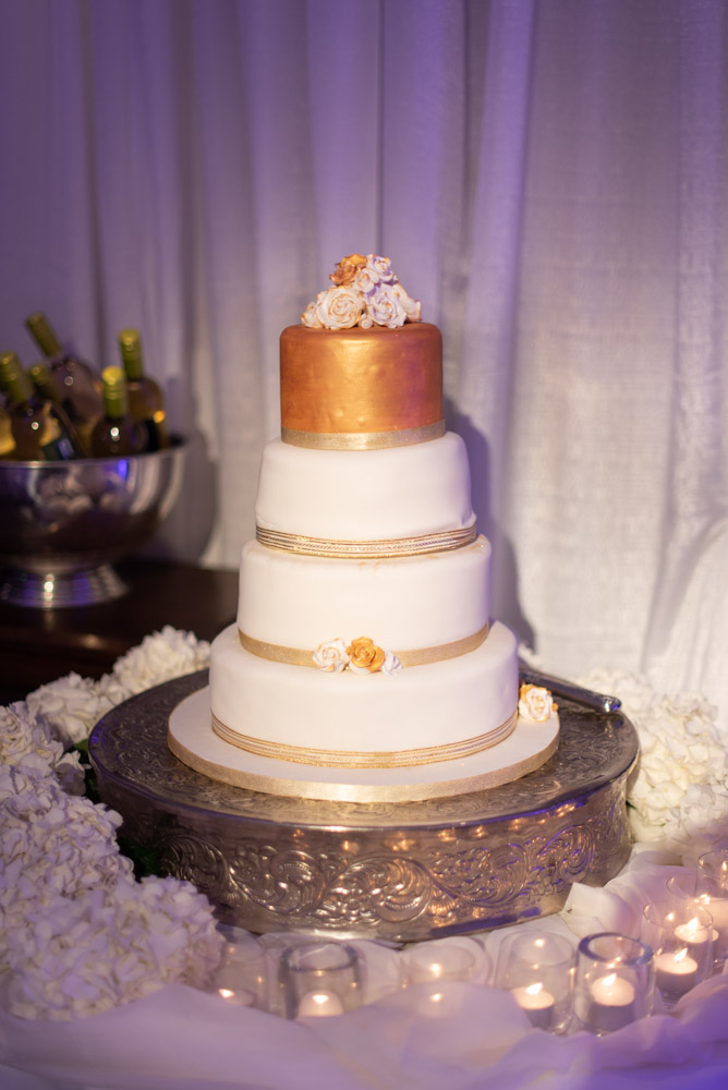 White and gold four tier wedding cake