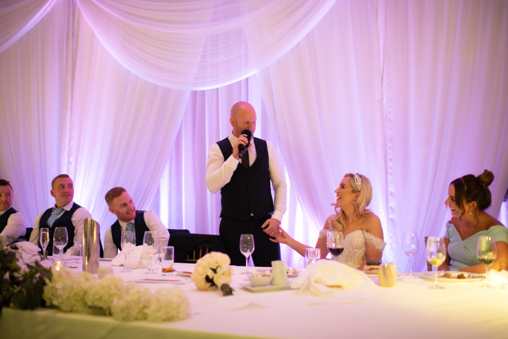 Groom at the top table standing giving his speech