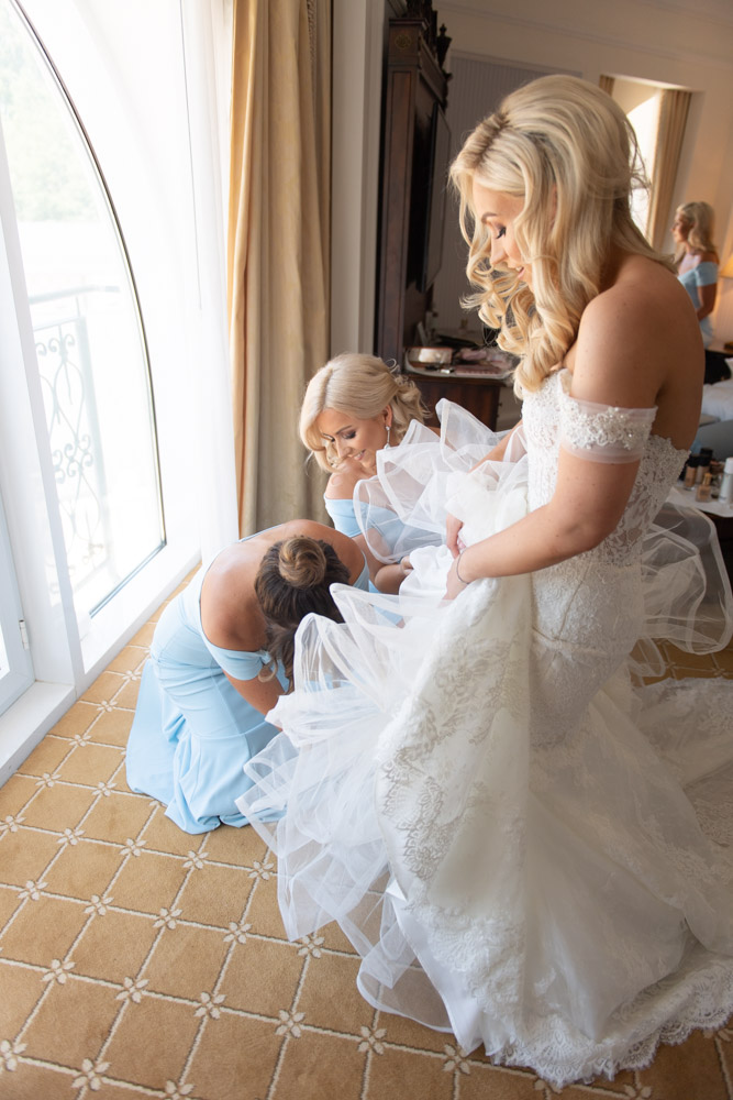 Bridesmaids helping the Bride into her wedding shoes