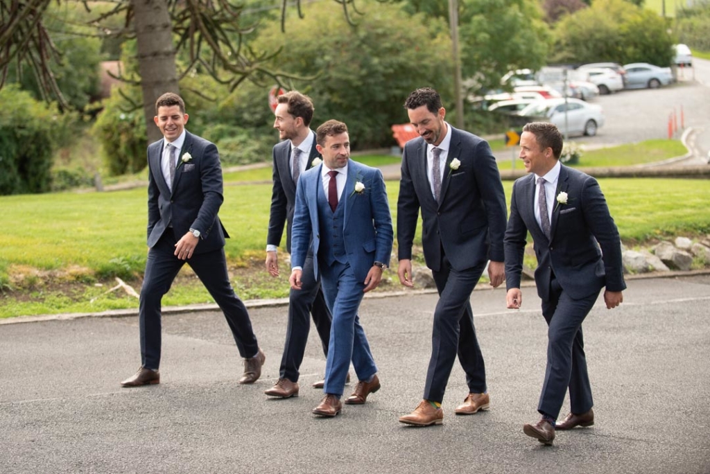 Groom and groomsmen walking up to the Church to get married