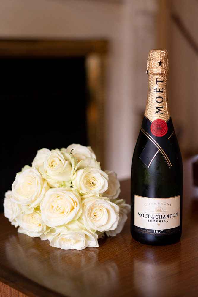 Bottle of Moet champagne and white rose bouquet