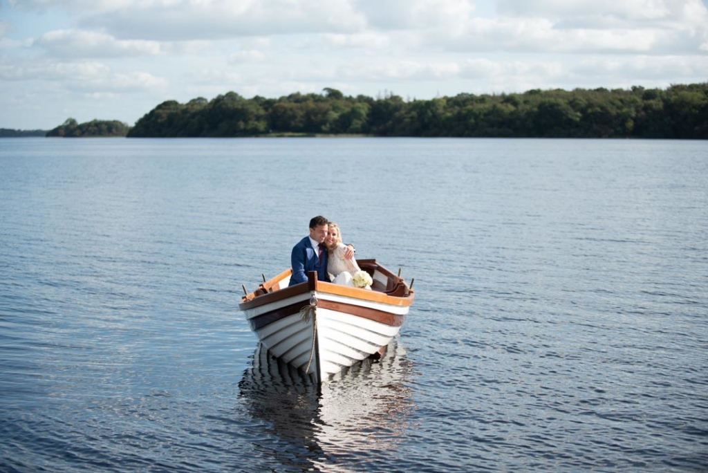 Bride and groom in a boat hugging on the lake at Virginia Park Lodge