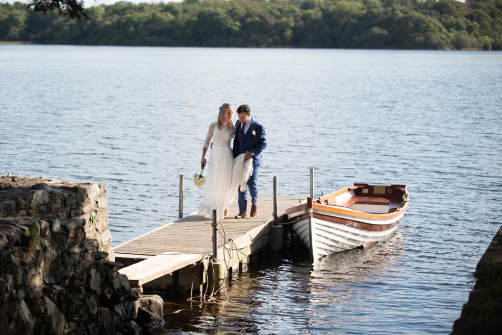 Bride and groom walking on the boardwalk on the lake at Virginia Park Lodge