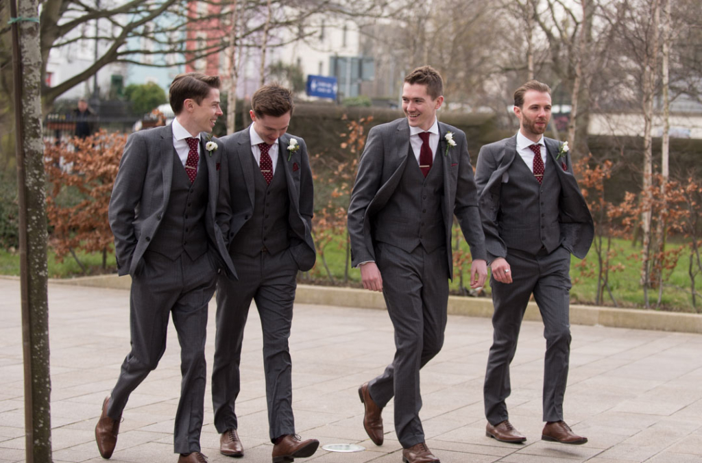 Groom and groomsmen walking into the Church