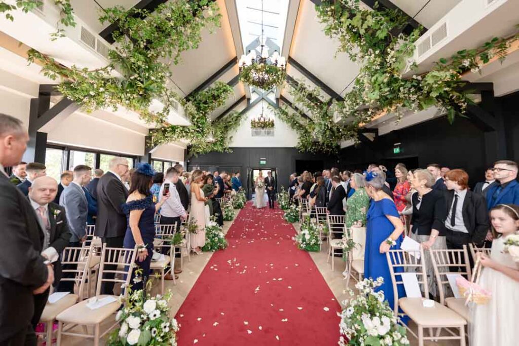 Bride walking up the aisle at the Cabra Castle ceremony room